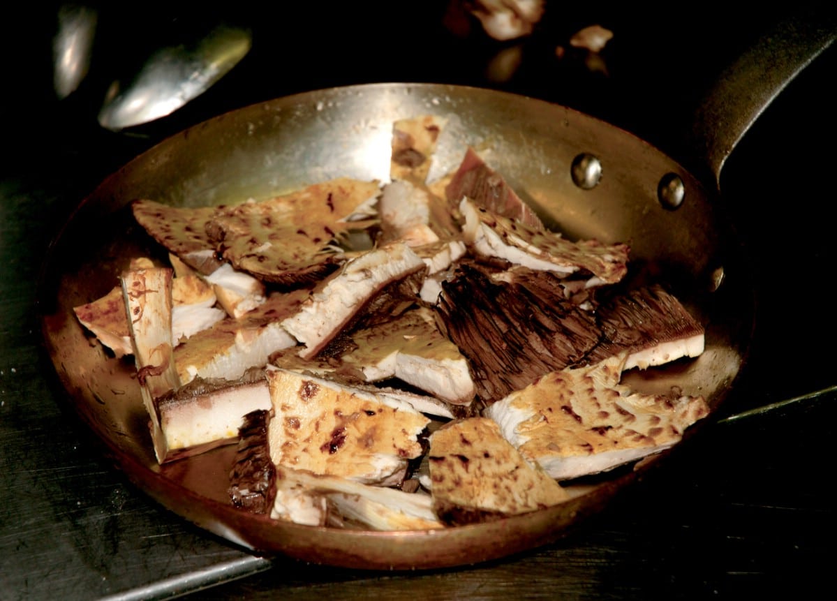 Sliced up prince agaricus in a frying pan