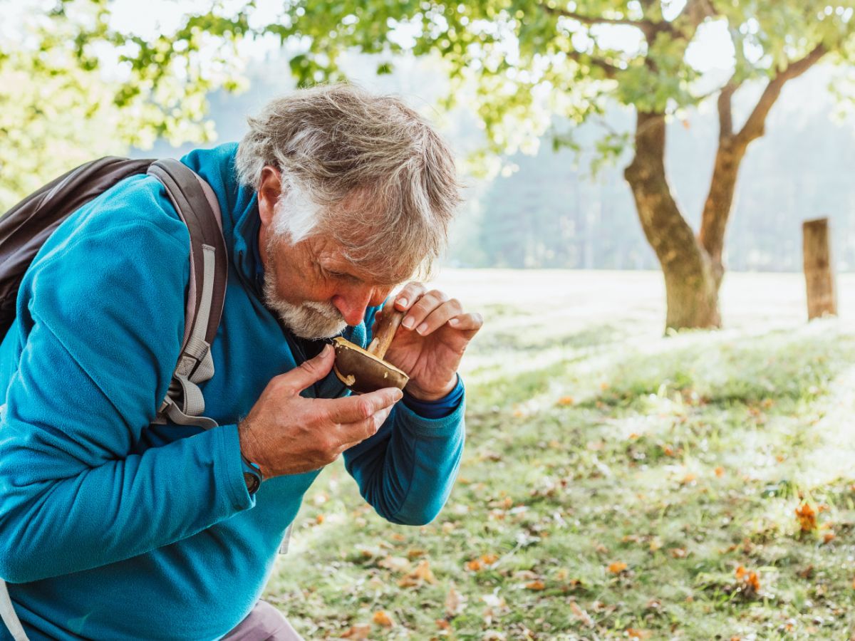 smelling a mushroom